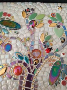 a mosaic tree with lots of different colors and shapes