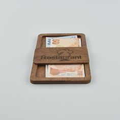 two wooden coasters with the word restaurant on one side and money in the other