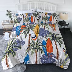 a bed with a palm tree and surfboards printed on the comforter, next to a night stand