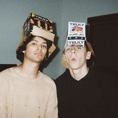 two men with hats on their heads standing next to each other