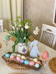 an easter table setting with eggs and flowers