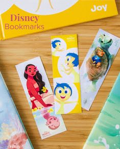 the disney bookmarks are lined up next to each other on top of a wooden table