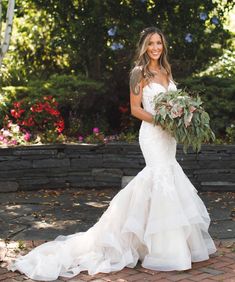 a woman in a wedding dress holding a bouquet