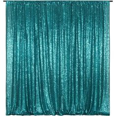 a teal colored backdrop with sequins on it and the curtain is closed