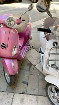 two pink scooters parked next to each other