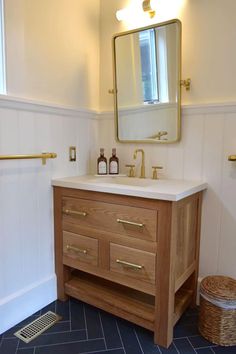 a bathroom with a sink, mirror and towel rack