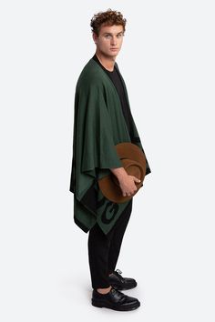 Inspired by the essential gaucho poncho, our unisex ruana is perfect for layering as the weather cools. Crafted from a sumptuous alpaca blend, the two-tone design is the definition of cozy elegance, with a bold yet restrained logo integrated into the hem. 50% alpaca, 45% acrylic, 5% wool Two front pockets Green with black logo lettering One Size Cape For Layering, Oversized Cape Wraps For Fall, Oversized Fall Cape Wrap, Oversized Cape Wraps For Winter, Oversized Winter Cape Wrap, Oversized Wool Poncho For Layering, Black Inspiration, Green And Black, Black Logo