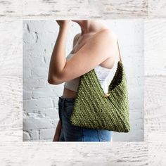 a woman holding a green knitted bag