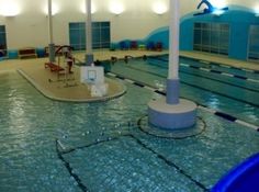 an indoor swimming pool with no people in it