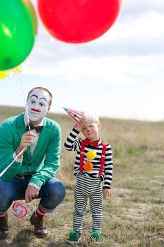 a man and child with clown makeup holding balloons