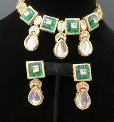 This beautiful choker is a modern twist to traditional jewelry and comes in a gold finish with green stones to match any outfit as desired. The choker is made of high quality stones and is a statement piece that can be dressed accordingly. The set comes with matching earrings for a complete look. Gold-plated Green Kundan Necklace With Meenakari, Green Kundan Necklace With Meenakari In Gold Plated, Green Kundan Necklace With Meenakari Detail, Gold Plated Green Jewelry Sets For Festivals, Green Gold-plated Kundan Necklace For Festivals, Green Gold Plated Kundan Necklace For Festivals, Green Gold-plated Jewelry Sets For Festivals, Festive Green Gold Plated Jewelry Sets, Festive Green Emerald Necklace With Jewels