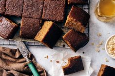 slices of brownie sitting on top of a cooling rack next to a bowl of oatmeal