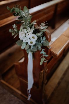 a bouquet of flowers is sitting on the pew