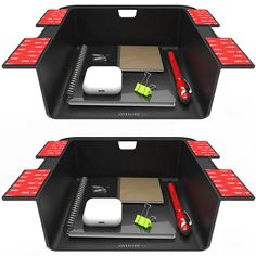 two black trays with red and green items in them on top of each other