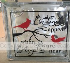 a glass block with red birds on it and the words, cardinals appear when boys are near