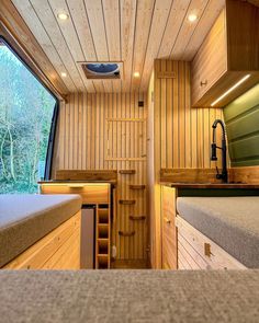 the interior of a small cabin with wood paneling