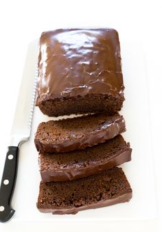 slices of chocolate cake sitting on top of a white cutting board