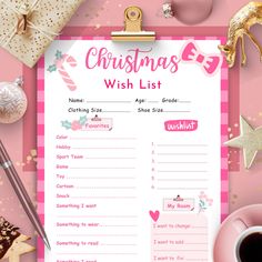 a pink christmas wish list on a clipboard next to presents and other items around it