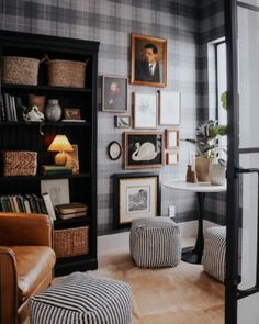 a living room filled with furniture and pictures on the wall