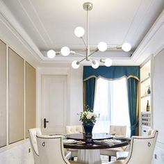 a dining room with white chairs and a round table