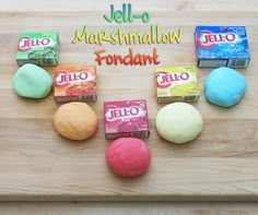 several different colored balls of play dough on a wooden surface with the word hello written in spanish