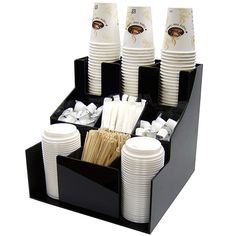 a cup holder with cups and paper straws in it on top of a table