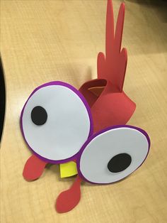 a close up of a paper bird on a table