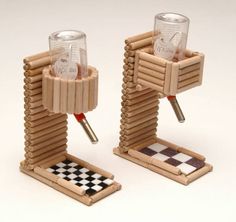 there are two glass holders made out of wooden sticks and some sort of checkerboard