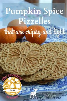 pumpkin spice pizzas that are crispy and light on a blue plate with oranges