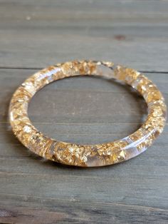 Beautiful clear Resin Bangle with gold flake ♥ Be sure to check out the NECKLACE section at EarringsbyLCreations for all kinds of necklaces available! https://www.etsy.com/shop/EarringsByLCreations?section_id=25034204 Made with quality materials and always nickel and lead free metals. Naturally colorful jewelry made by hand to complement your beauty.  Perfect gift for a friend or loved one: All jewelry pieces are packaged in jewelry boxes, wrapped in burlap ribbons and gold twine thread. Rustic Handmade Gold Crystal Round Bracelet, Handmade Gold Crystal Bracelet, Gold Crystal Bangle Bracelet For Gift, Gold Flake, Resin Bracelet, Resin Bangles, Bangle Gold, Wrist Bracelet, The Bangles