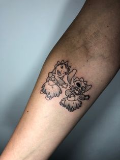 a person with a tattoo on their arm holding onto the arm of another person's arm