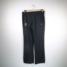 black nike pants hanging up on a hanger