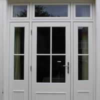 two white double doors with sidelights and windows on either side of the door are open