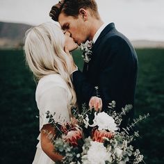 a bride and groom standing next to each other