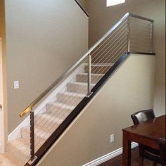 the stairs in this house are made of wood and metal, with an iron handrail