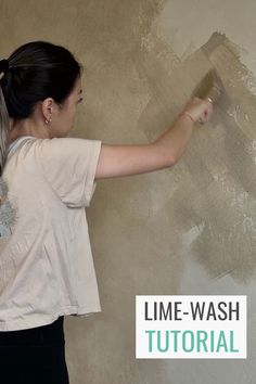 a woman painting a wall with paint rollers in her hand and the words time - wash on it