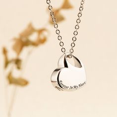 This heart-shaped urn drop necklace is not just a piece of jewelry; it's a precious keepsake that allows you to hold the memories of your loved ones close to your heart. Whether it's a cherished human companion or a beloved pet, this necklace is a touching way to keep their ashes with you, a beautiful remembrance of the love and connection you shared. Key Features: Handmade Craftsmanship: Each heart-shaped urn drop necklace is meticulously handcrafted with care and attention to detail. Our skill Double Heart Necklace For Mother's Day Memorial, Personalized Heart Charm Necklace For Memorial, Memorial Valentine's Day Heart Pendant Charm Necklaces, Memorial Mother's Day Double Heart Necklace, Heart-shaped Engraved Necklaces For Memorial, Personalized Silver Heart Necklace For Memorial, Engraved Heart Necklace For Mother's Day Memorial, Engraved Heart Necklace For Valentine's Day Memorial, Silver Heart Necklace For Keepsake