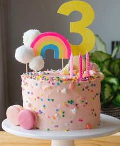 a birthday cake with pink frosting and sprinkles