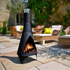 an outdoor fire pit sitting on top of a patio