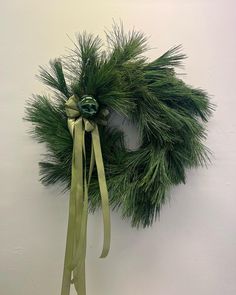 a green wreath hanging from the side of a wall