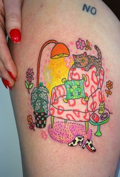 a woman's thigh with an image of a cat on the couch and flowers