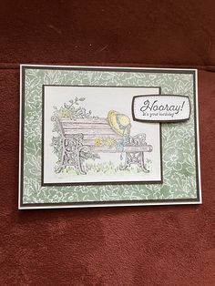 a close up of a card with a bench on the side and a sticker that says happy birthday