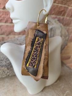 Handmade brown leather earrings with animal print accents Chic Brown Dangle Jewelry, Brown Small Hoop Earrings With Ear Wire, Unique Brown Hoop Earrings For Gift, Handmade Brown Faux Leather Earrings, Handmade Brown Hoop Earrings For Everyday Wear, Everyday Handmade Brown Hoop Earrings, Brown Hoop Earrings With Ear Wire, Trendy Brown Dangle Earrings, Brown Single Hoop Earring As Gift