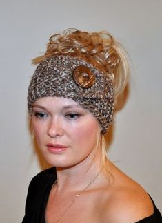 a woman with blonde hair wearing a knitted headband