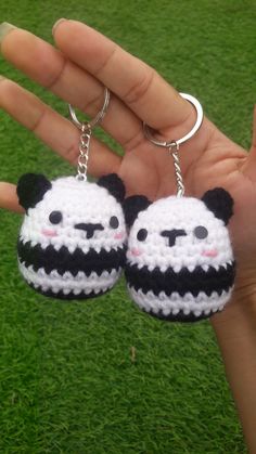 two little panda keychains in the palm of someone's hand