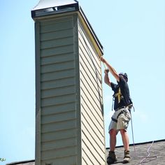 a man working on the roof of a house