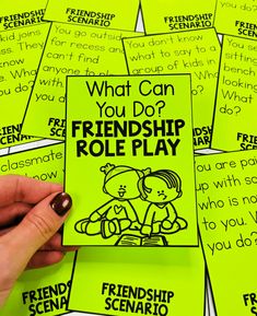 a person holding up a card with the words, what can you do? and friends role play on it