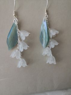 "*Free shipping on orders more than $35 in U.S. Territories ⭐Stunning delicate lily of the valley drop earrings Perfect gift idea for garden lovers or a treat for yourself Light weight and comfortable to wear everyday. They are very cute and romantic, will easily blend with your style. 📌DETAILS *Quantity: 1 pair *Measurements:    6 flowers:Length 6.7cm (2.63\"), Drop 4.2cm (1.65\"), Width 2 cm (0.78\")   4 flowers:Length 6.7cm (2.63\"), Drop 4.2cm (1.65\"), Width 2 cm (0.78\") *Materials: bronze with gold plated(nickel free)/   acrylic/ natural freshwater pearl 📌NOTES Due to the variations in pearls, no two earrings will ever be the same so you'll always have a unique look. Colors may vary slightly due to different computer monitor settings. Substances like oil, nail polish, nail polish Handmade Ethereal Dangle Jewelry, Ethereal Handmade Dangle Jewelry, Handmade Ethereal Dangle Earrings, Ethereal Handmade Dangle Earrings, Whimsical Dangle Earrings With Flower Charm, Delicate Handmade Chandelier Earrings Gift, Delicate Handmade Chandelier Earrings For Gift, Delicate Handmade Dangle Earrings, Flower Cottagecore