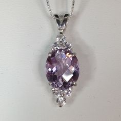 Gorgeous Rose de France Lavender Amethyst & White Sapphire Pendant Necklace * Genuine Oval Cut Rose de France  Amethyst Measures 12mm x 10mm * 6 Brilliant Cut White Sapphires measure 3mm each * 6cts total Gemstone weight * Solid Sterling Silver - also available in 14kt Yellow or White Gold message me for details) * 18" Sterling Silver Chain Included Hallmarked & Gift Ready! Matching Ring also available here  https://www.etsy.com/listing/457747894/beautiful-65ct-lavender-amethyst-white TIMELESS, BEAUTIFUL & UNIQUE FINE ART JEWELRY Sapphire Pendant Necklace, Clear Crystal Necklace, Lavender Amethyst, Sapphire Necklace Pendants, Jewelry Bracelets Silver, Fine Art Jewelry, Big Rings, Sapphire Pendant, Sterling Silver Necklace Pendants