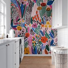 a colorful wallpaper with flowers and plants on it in a kitchen area next to a washer